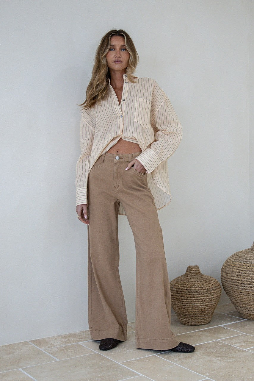 Brownstone Straight Leg Flare Jeans warm beige – outdoor lifestyle shot styled with lemon striped shirt