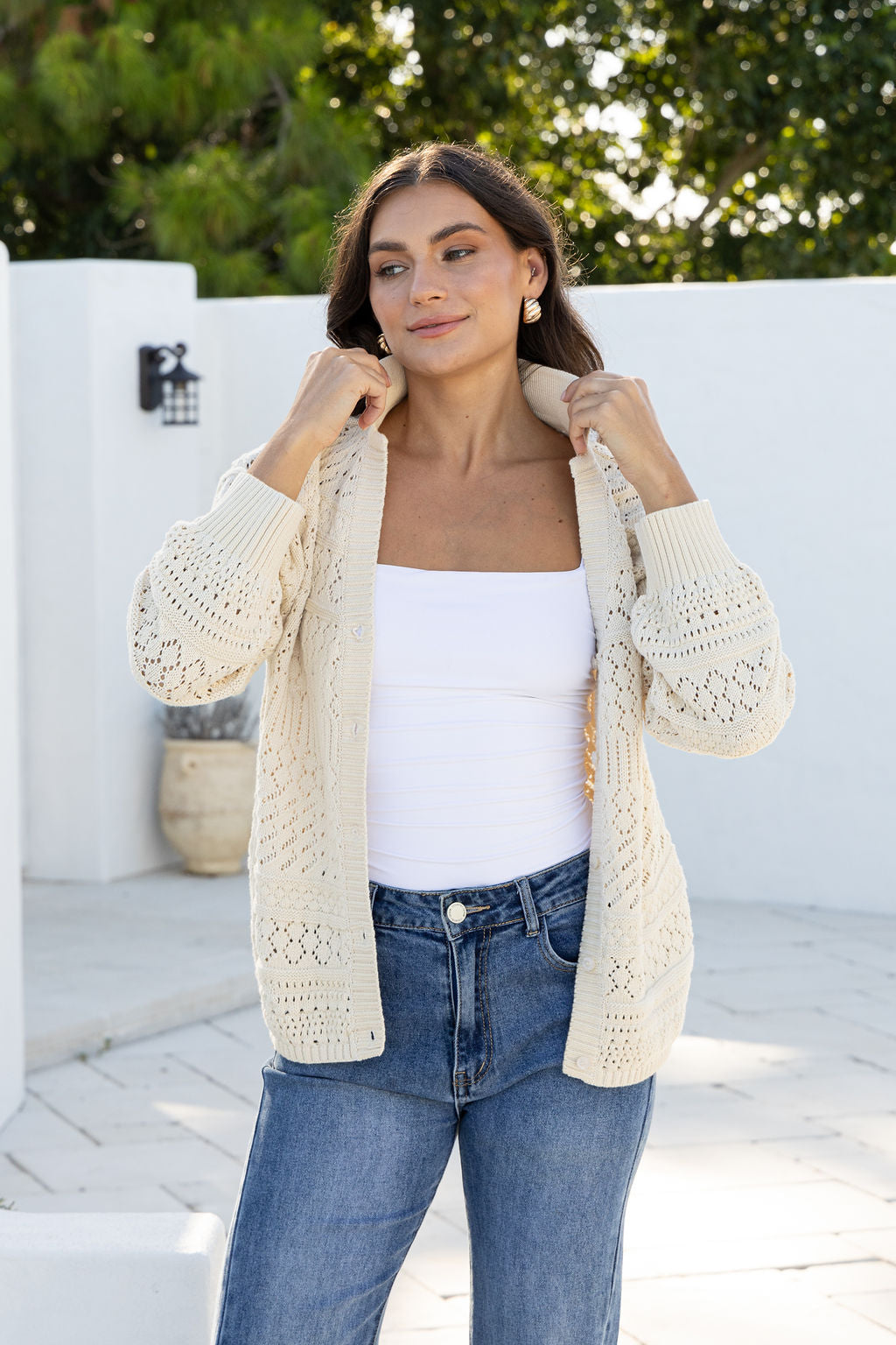 Cloud Dancer Crochet Cardigan natural cream – model holding collar open to show detail