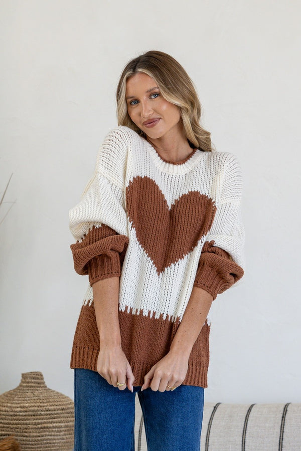 J'adore Heart Knit Jumper brown and cream by Miss Marlow – model hugging arms in to show heart detail on front
