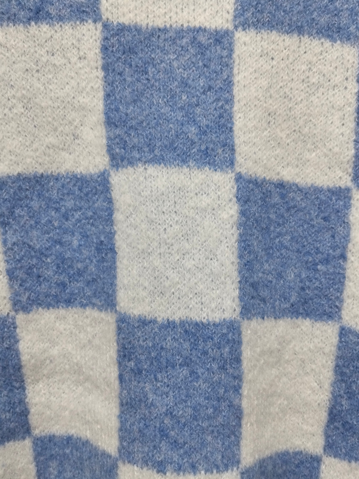 Monti Checker Knit Cardi powder blue and white – flat lay close-up of powder blue and white checker pattern