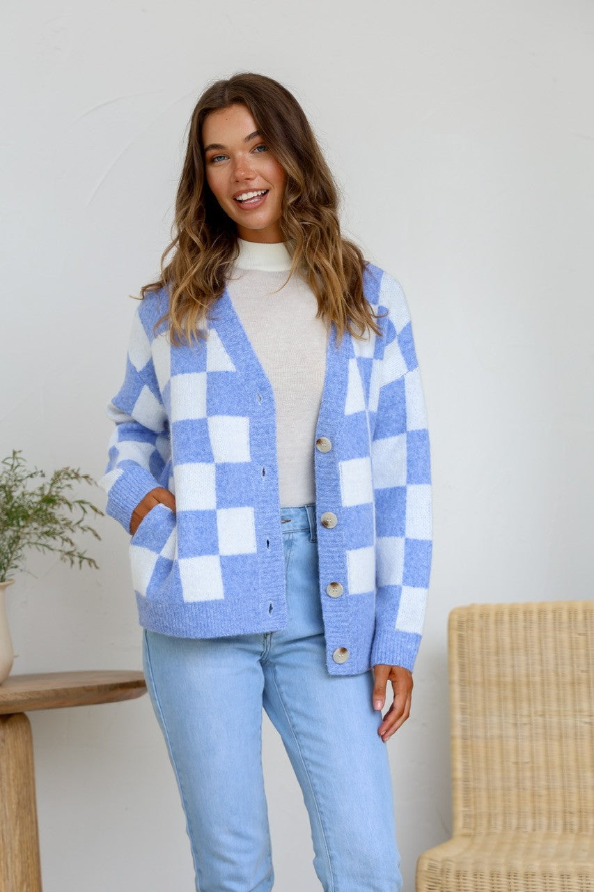 Monti Checker Knit Cardi powder blue and white – model with hand in pocket, cardi open over white tee