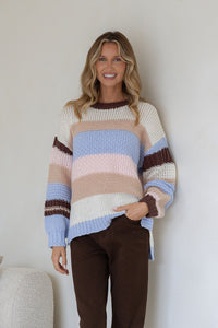 Bastille Chunky Knit Jumper blue stripe – close-up of smiling model with hand in pocket of chocolate brown jeans