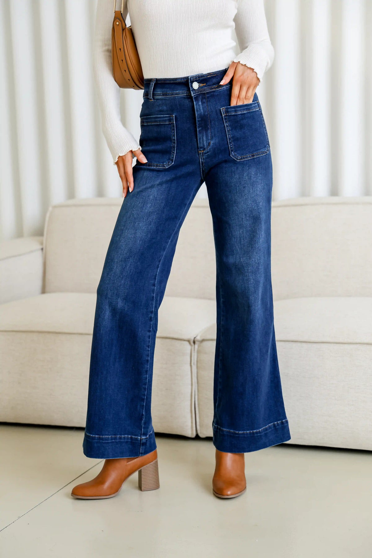 Sailor Wide Leg Pocket Jeans dark blue – close-up front shot with hand in pocket, white top, tan boots and handbag