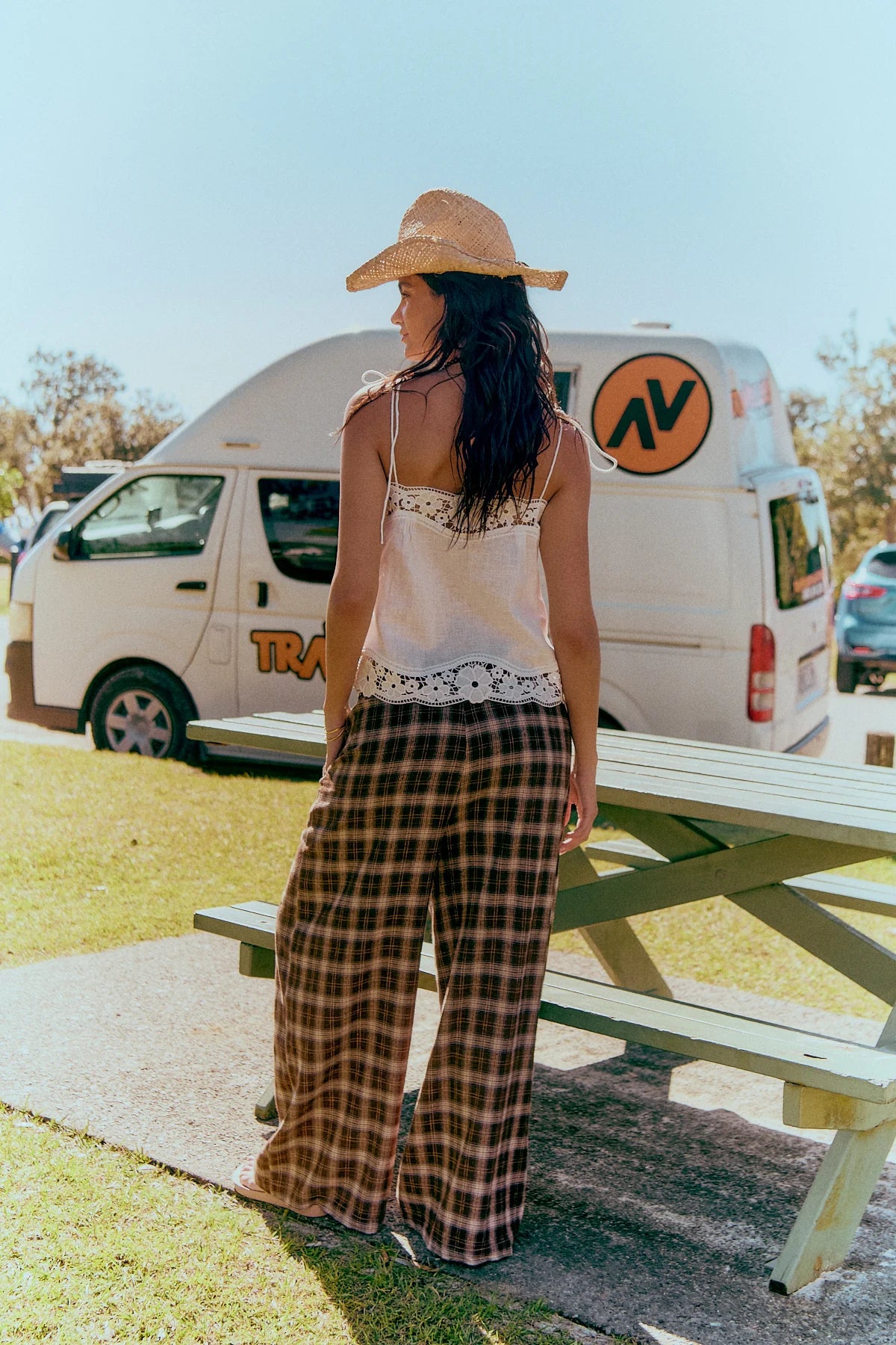 Jaase Stevie Austin Flannel Pants chocolate by Jaase – model standing at beach park showing back view of pants outdoor lifestyle shot