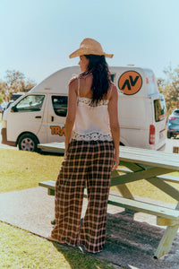 Jaase Stevie Austin Flannel Pants chocolate by Jaase – model standing at beach park showing back view of pants outdoor lifestyle shot