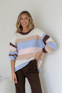 Bastille Chunky Knit Jumper blue stripe – model lifting side hem to show hi-low length