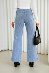 Sailor Wide Leg Pocket Jeans light blue – model back shot styled with white top, black bag and shoes