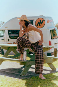 Jaase Stevie Austin Flannel Pants chocolate by Jaase – model sitting on park bench with elbow on knee hand under chin outdoor lifestyle shot