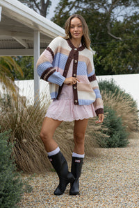 Model wearing Bastille Chunky Cardi blue stripe – outdoor lifestyle shot