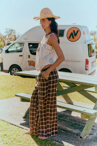 Jaase Stevie Austin Flannel Pants chocolate by Jaase – model standing at beach park showing side view of pants outdoor lifestyle shot